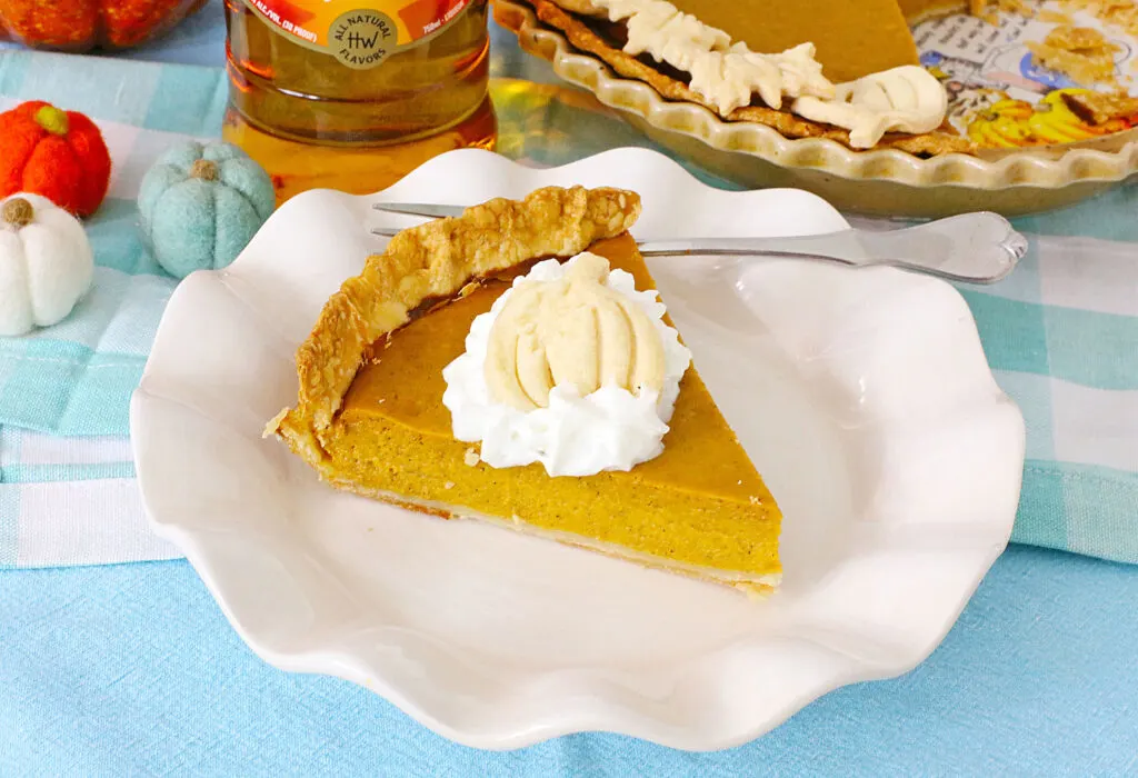 slice of boozy pumpkin pie on white plate