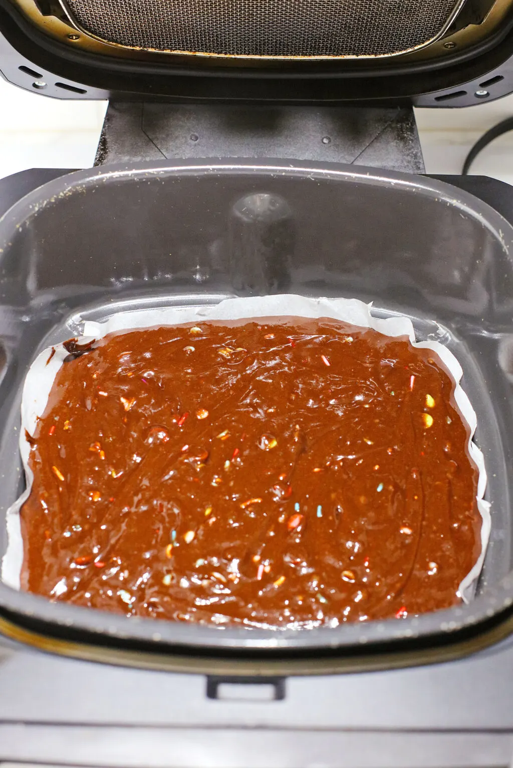 brownie batter poured into air fryer pan