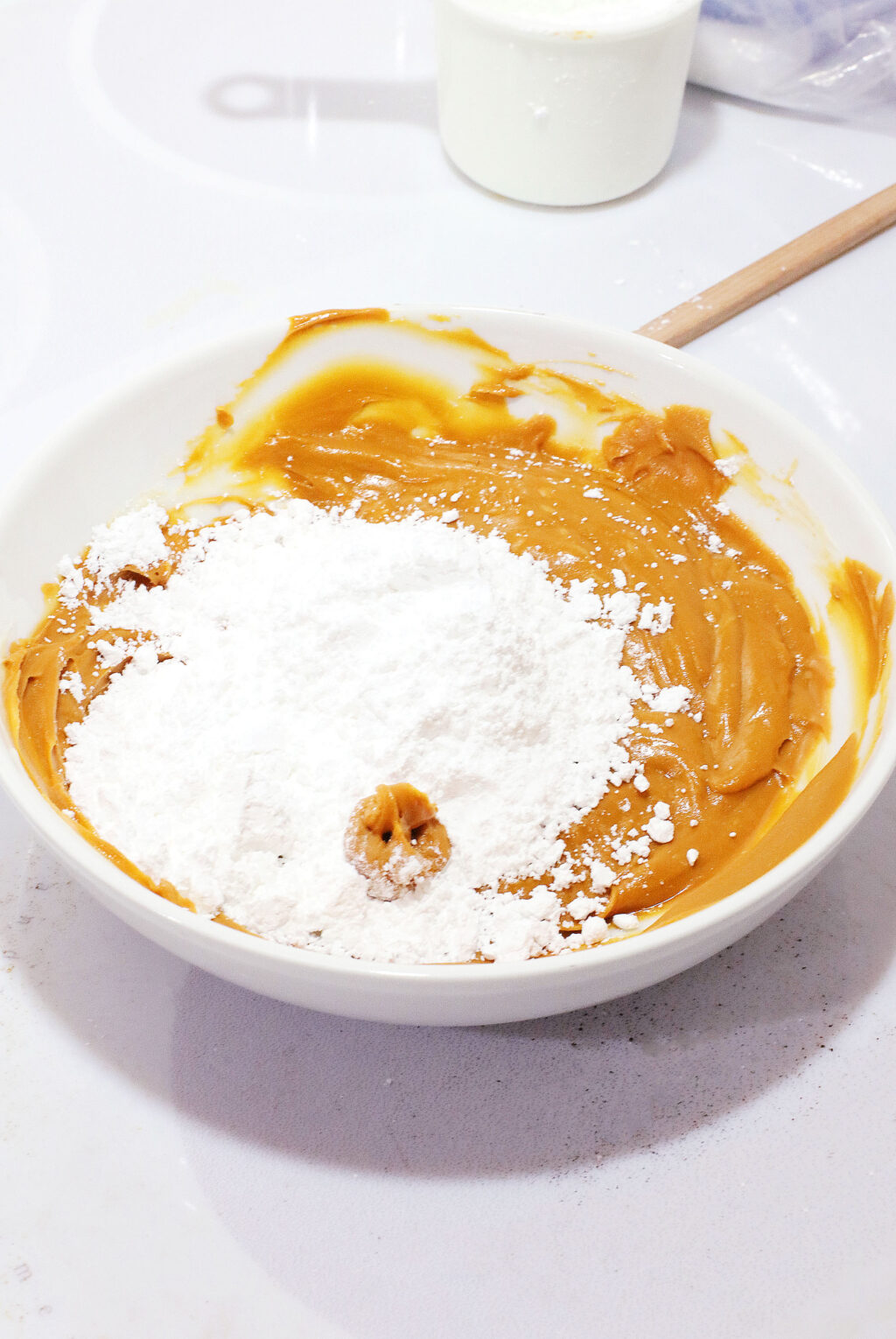 powdered sugar and peanut butter in large white mixing bowl