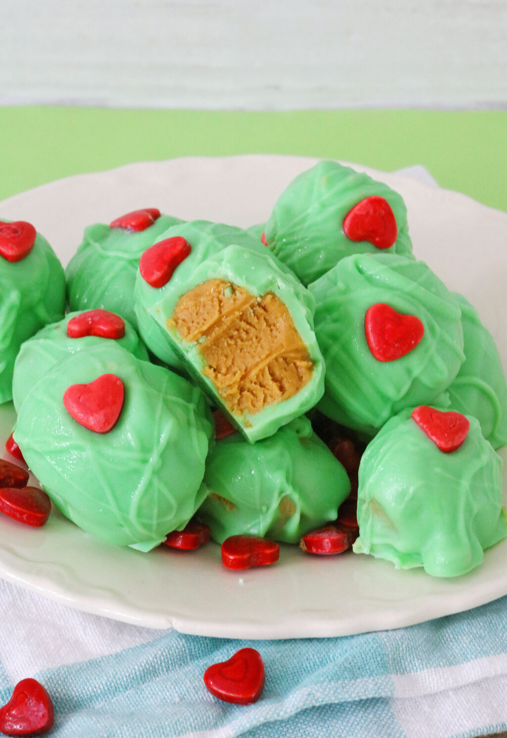 grinch peanut butter balls on white plate