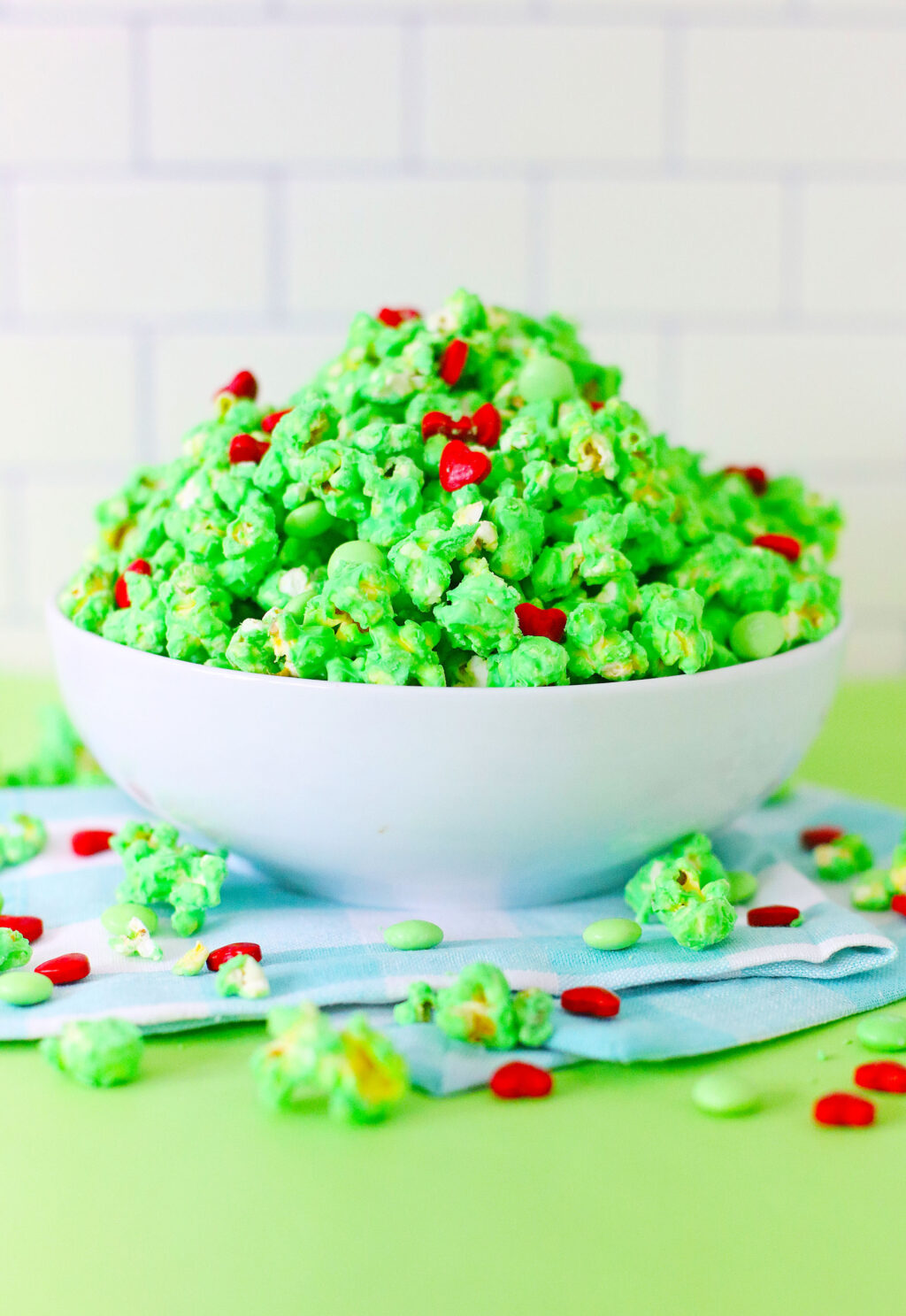 grinch popcorn in a large white bowl
