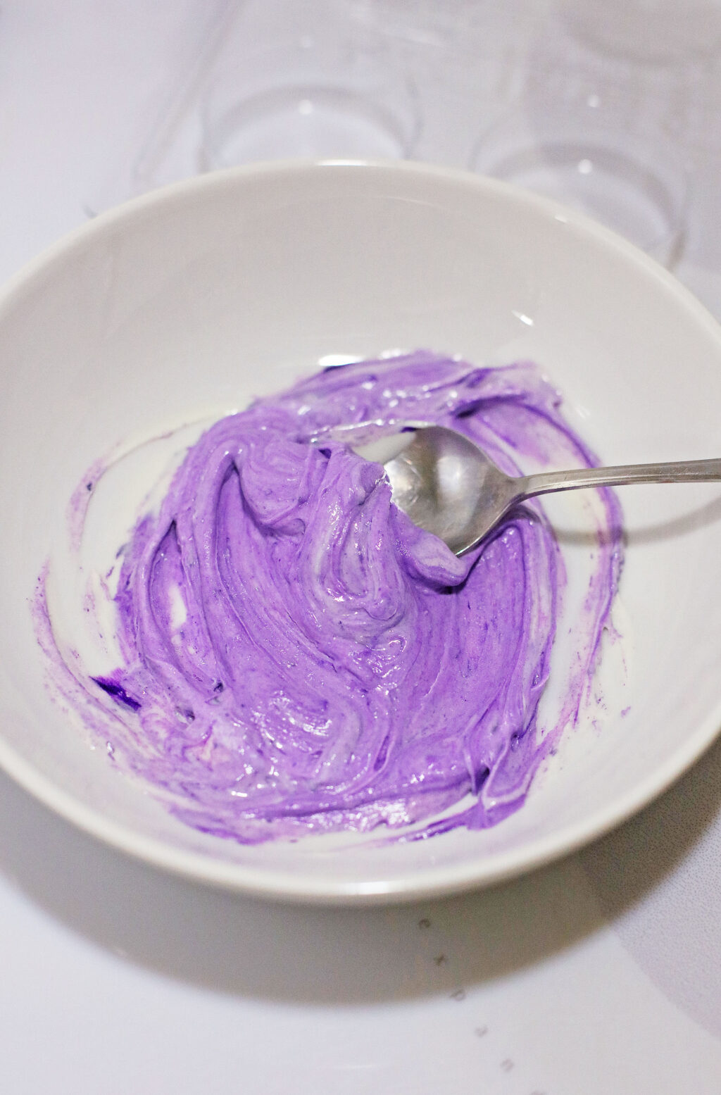 melted purple chocolate in white bowl