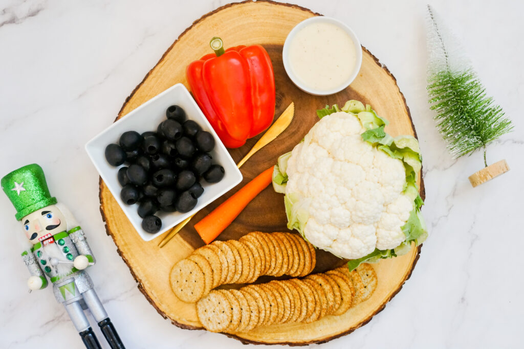 Snowman veggie tray ingredients on serving platter