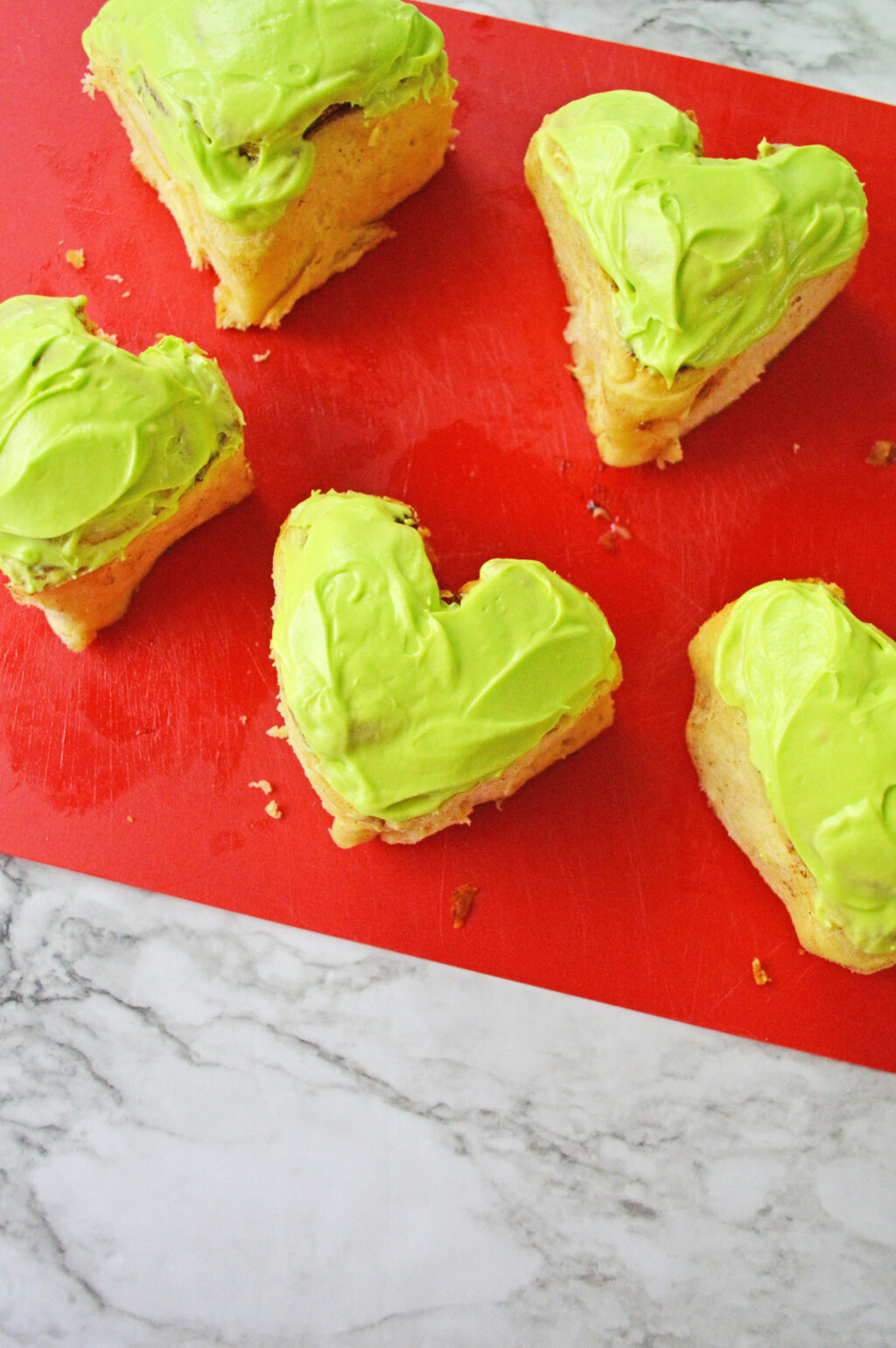 frosted heart cinnamon rolls with green frosting
