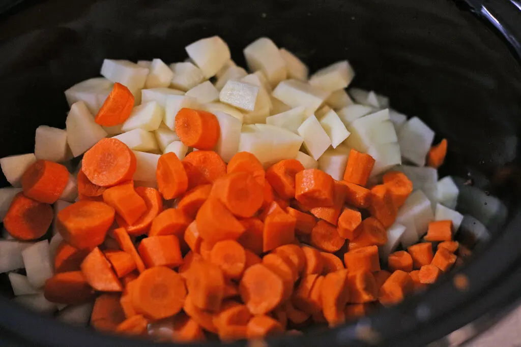 diced onions and carrots in a slow cooker