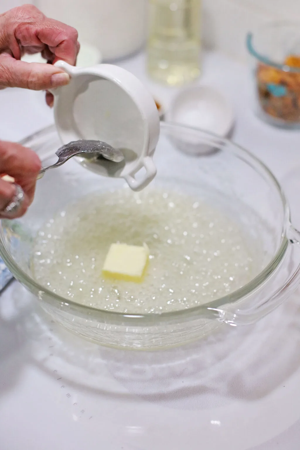 melted butter in bowl of hot candy mixture