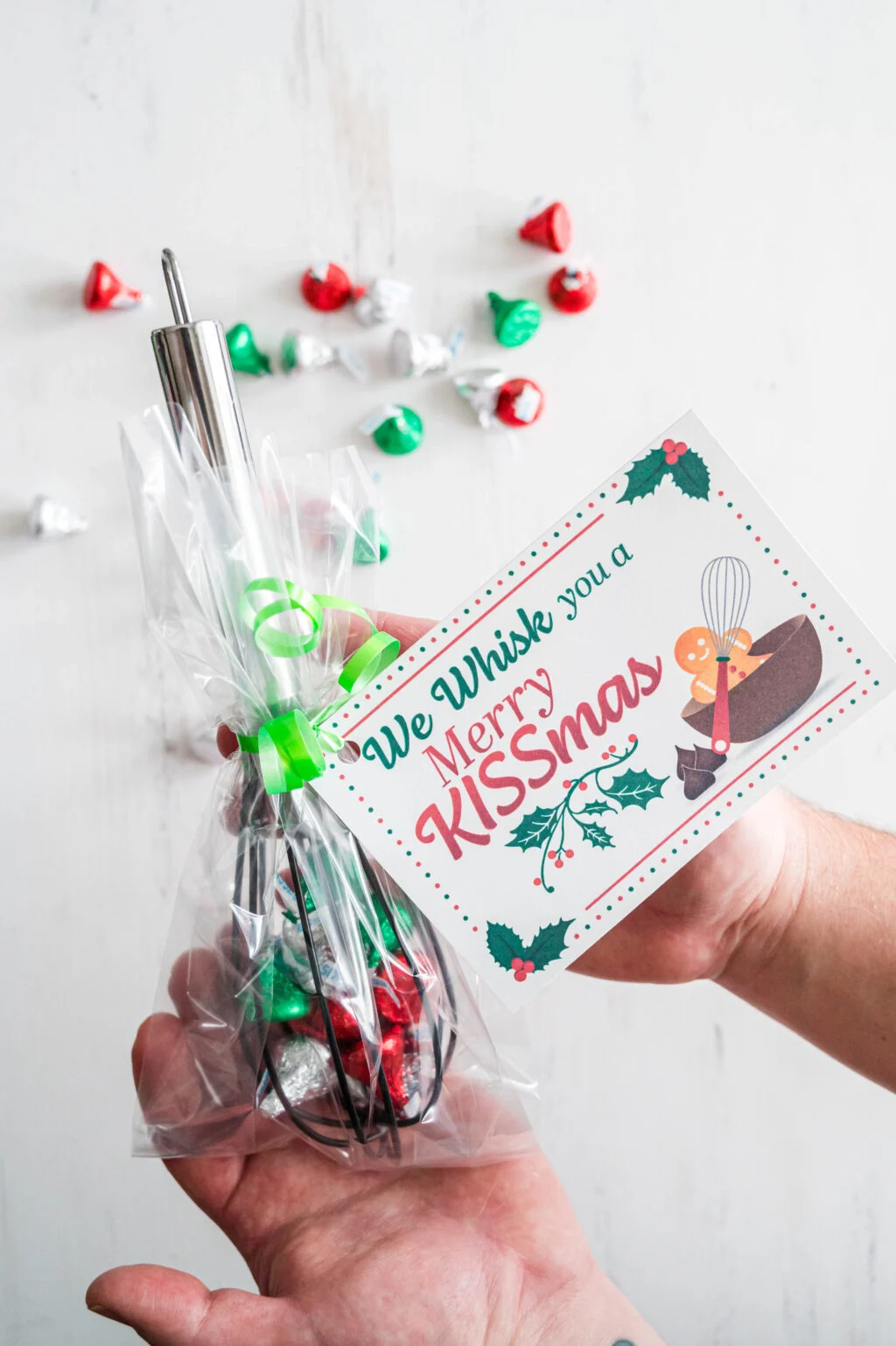 hand holding we whisk you a merry kissmas gift