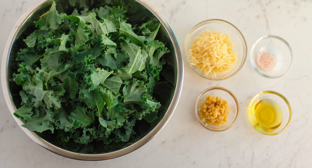 crispy kale chips ingredients in clear bowls on a table