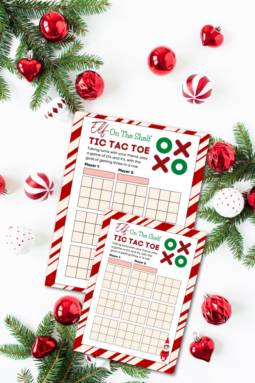 table with printable elf on the shelf tic tac toe board on it