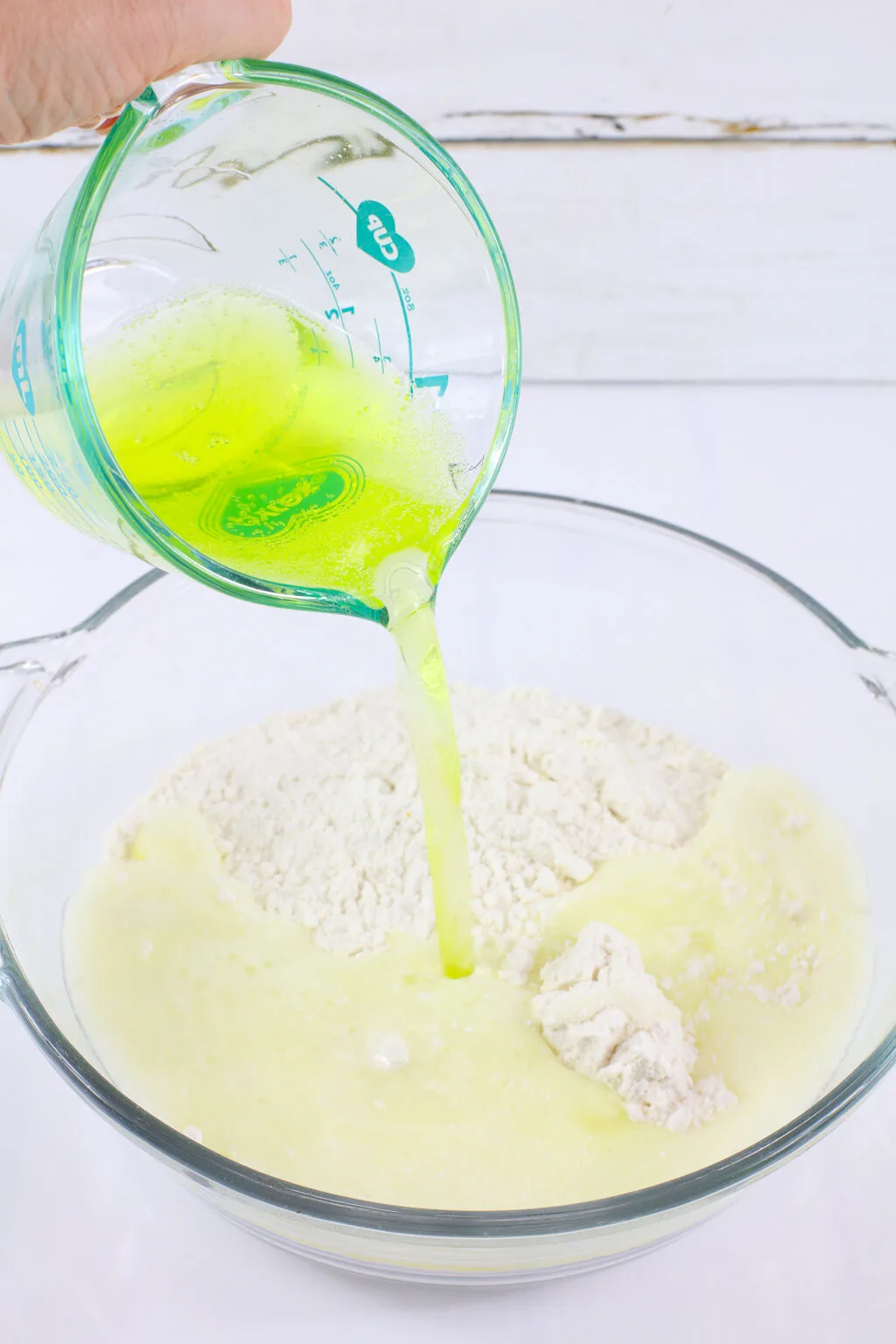 mountain dew being poured into cake mix