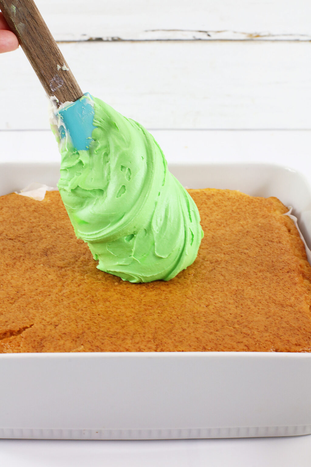 green frosting on top of baked cake