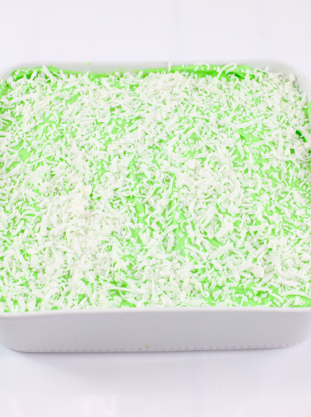 shredded coconut on top of mountain dew cake