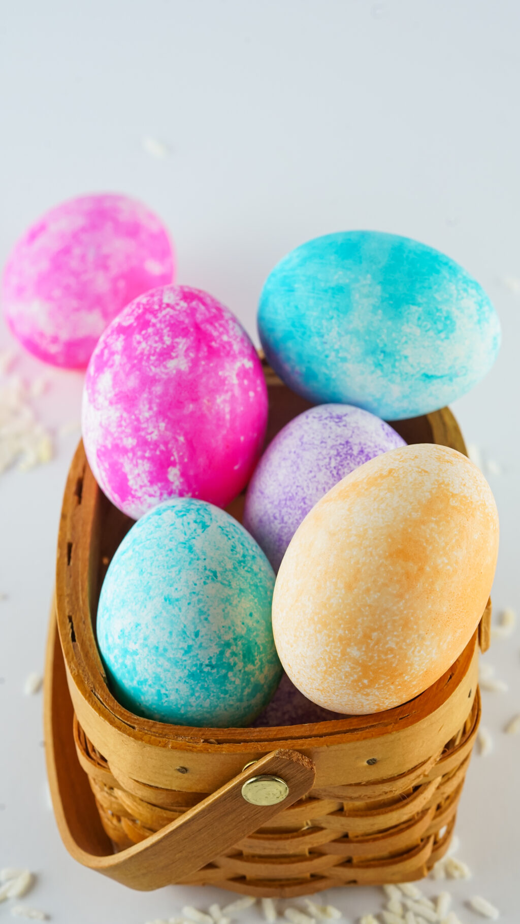 rice dyed easter eggs in wooden basket