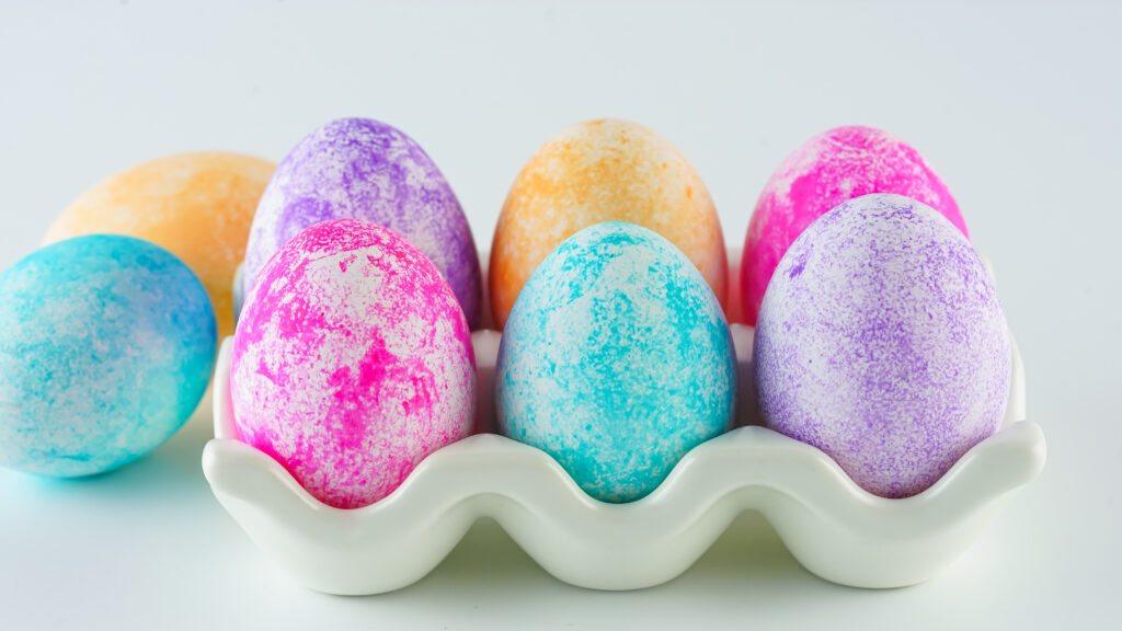 rice dyed easter eggs in white egg carton