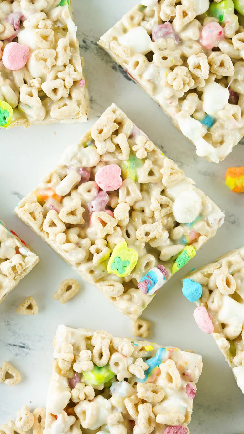 lucky charms rice krispies treats cut into squares on table