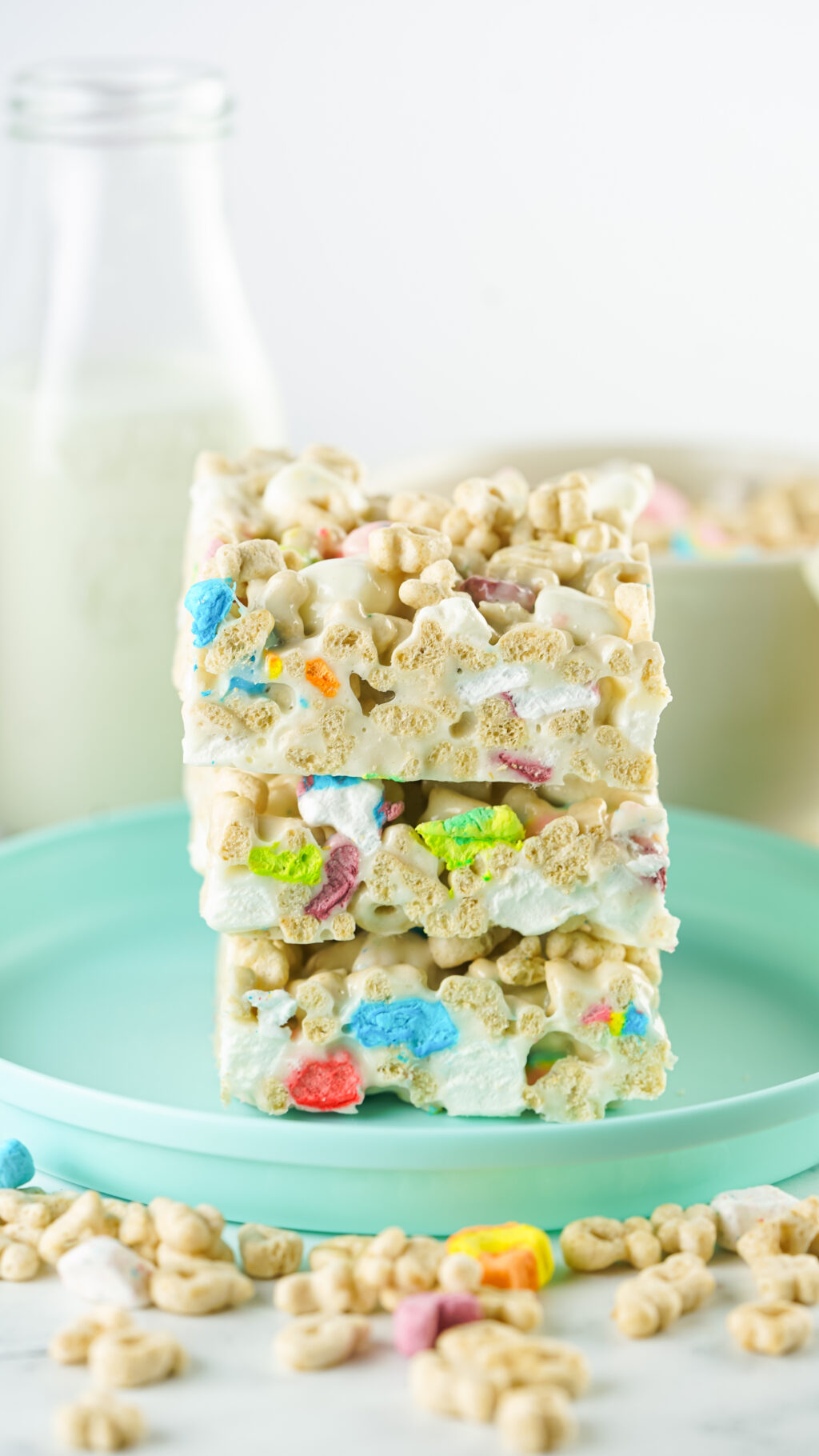 stacked lucky charms rice krispies treats on a aqua plate