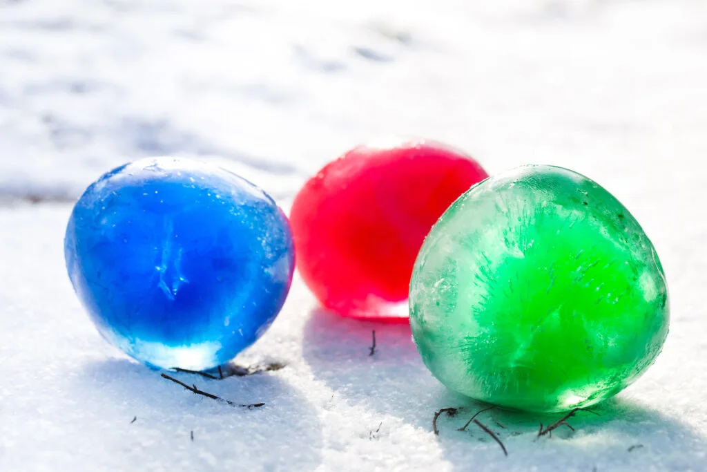 colored ice marbles on snow