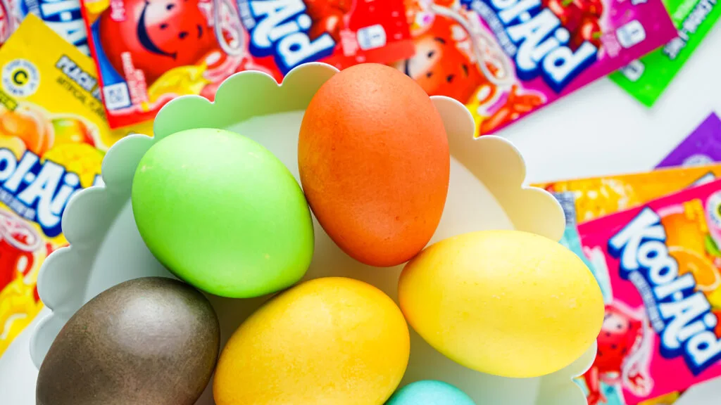 colorful kool-aid dyed easter eggs on white tray