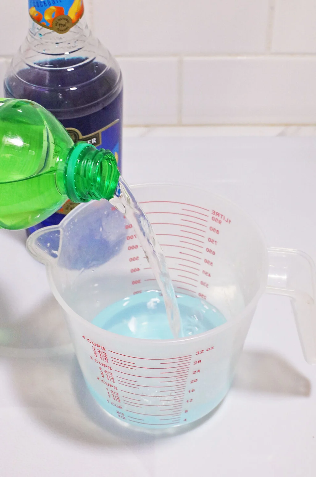 mountain dew being poured into measuring cup