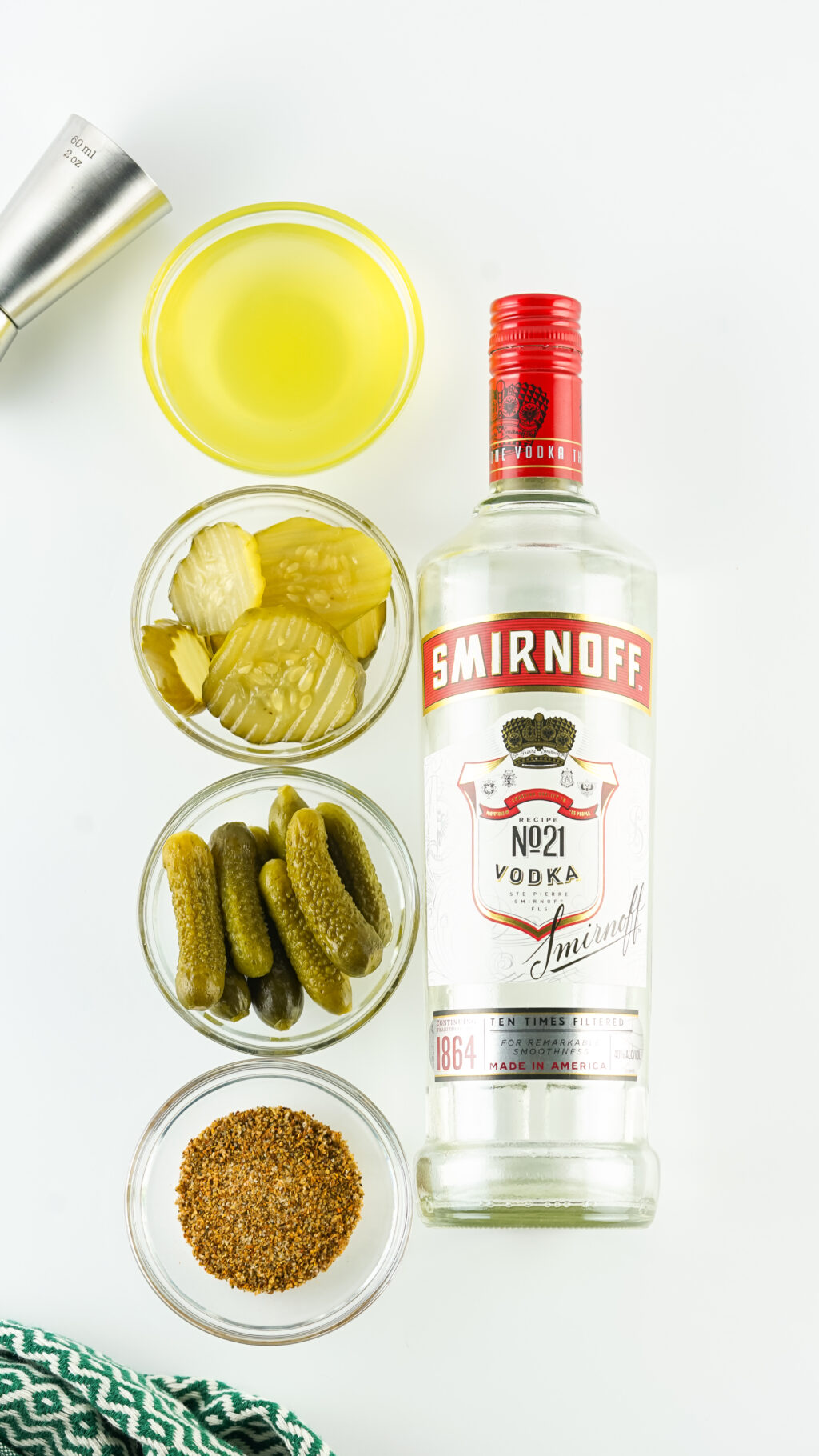 pickle shots with vodka ingredients on white table