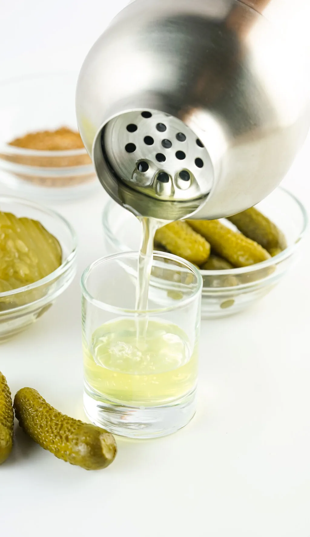pickle shot being poured into shot glass