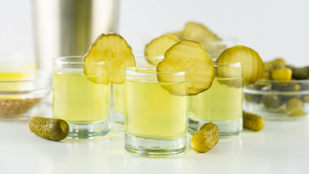 pickle shots in shot glasses on white table