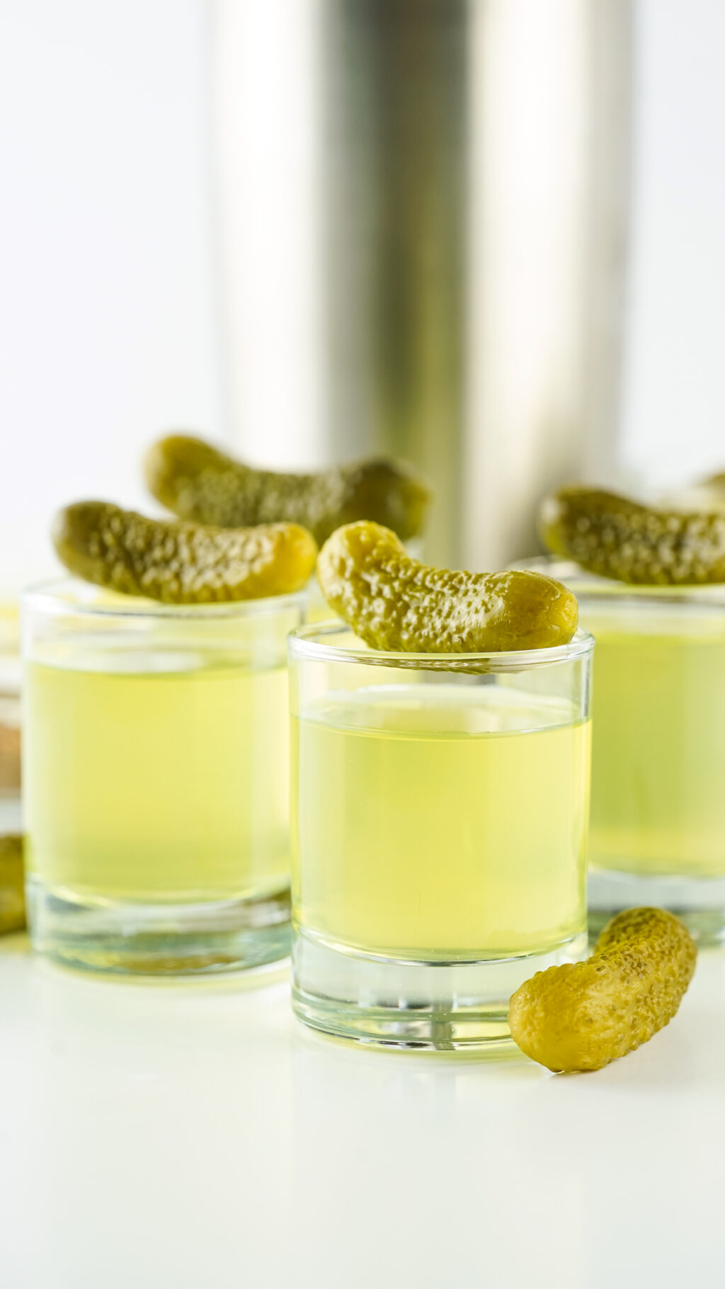 shot glasses filled with pickle shots with vodka