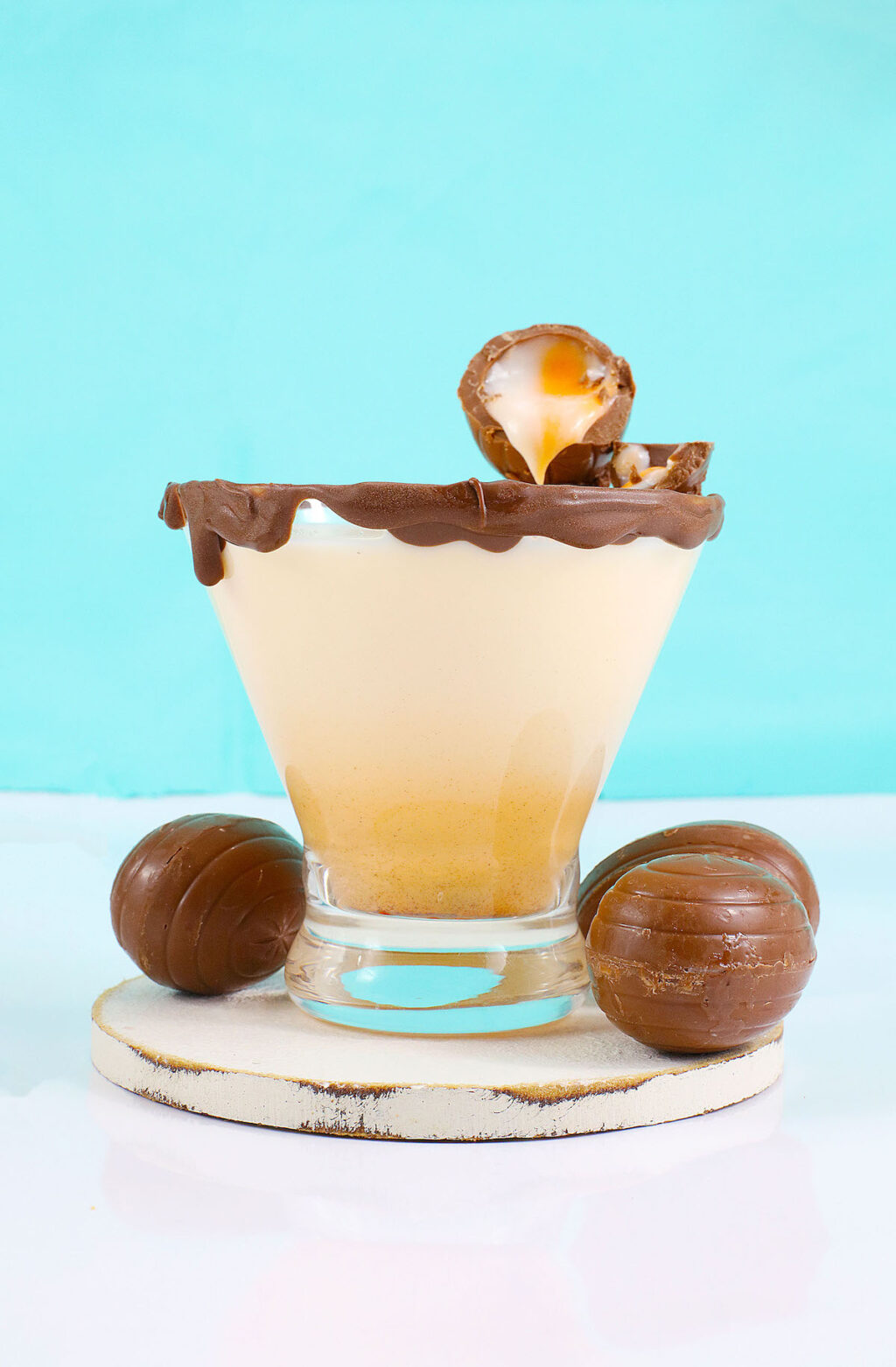 cadbury creme egg cocktail on white table with blue background
