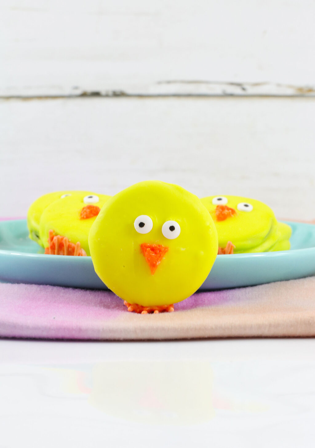 easter oreo chick leaning against blue plate
