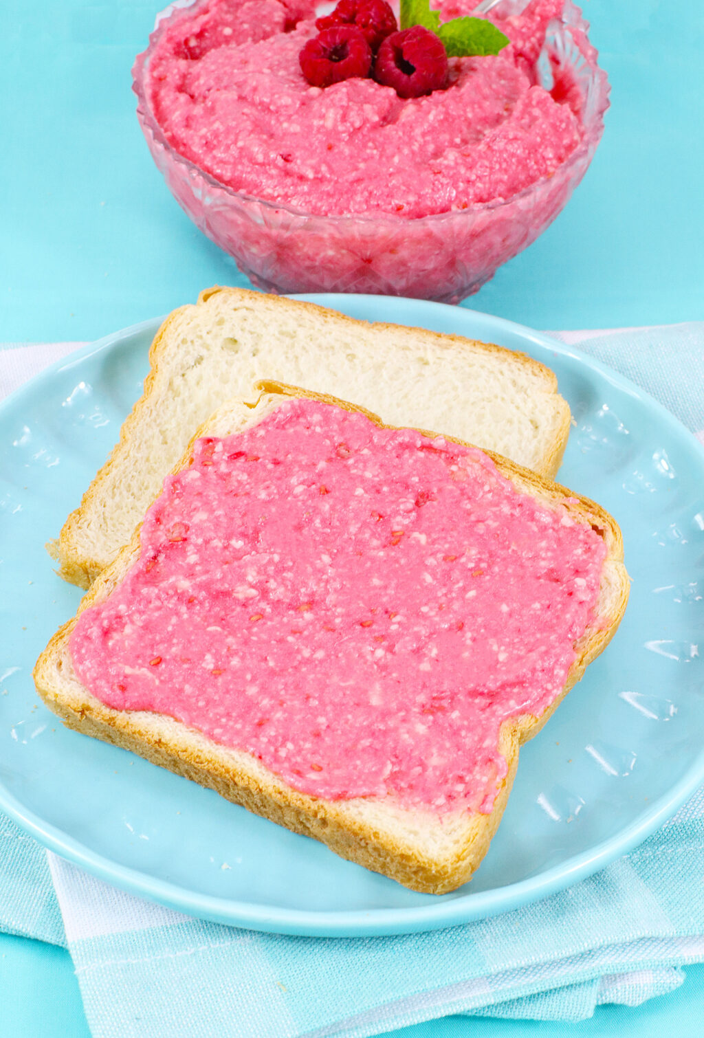 sliced of bread with raspberry butter spread on top