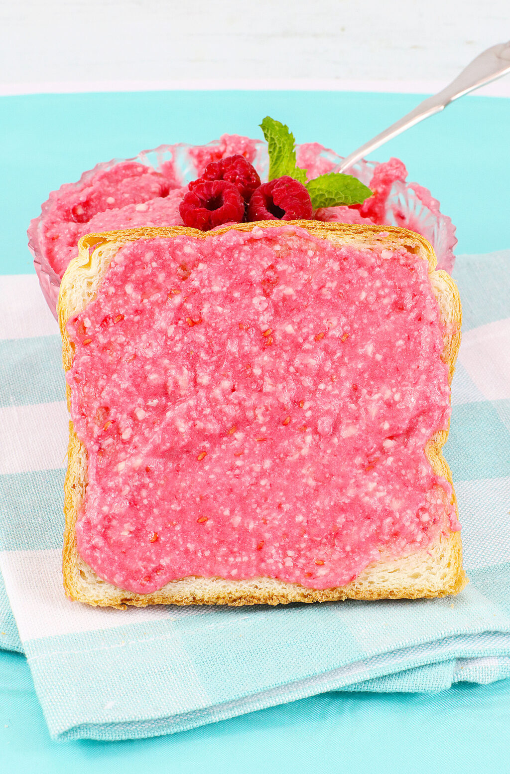 raspberry butter spread on a slice of bread