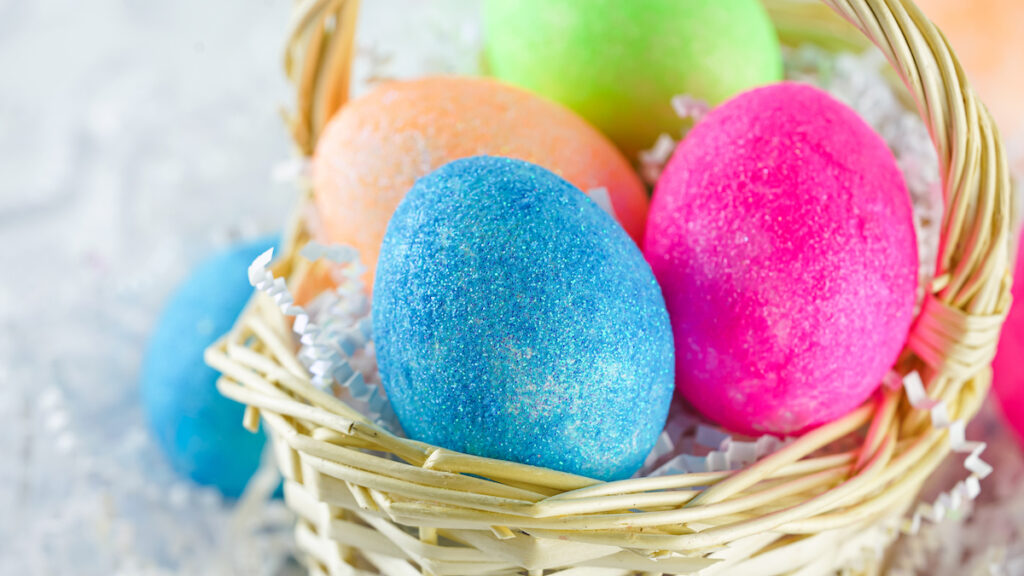 colorful glitter easter eggs in easter basket
