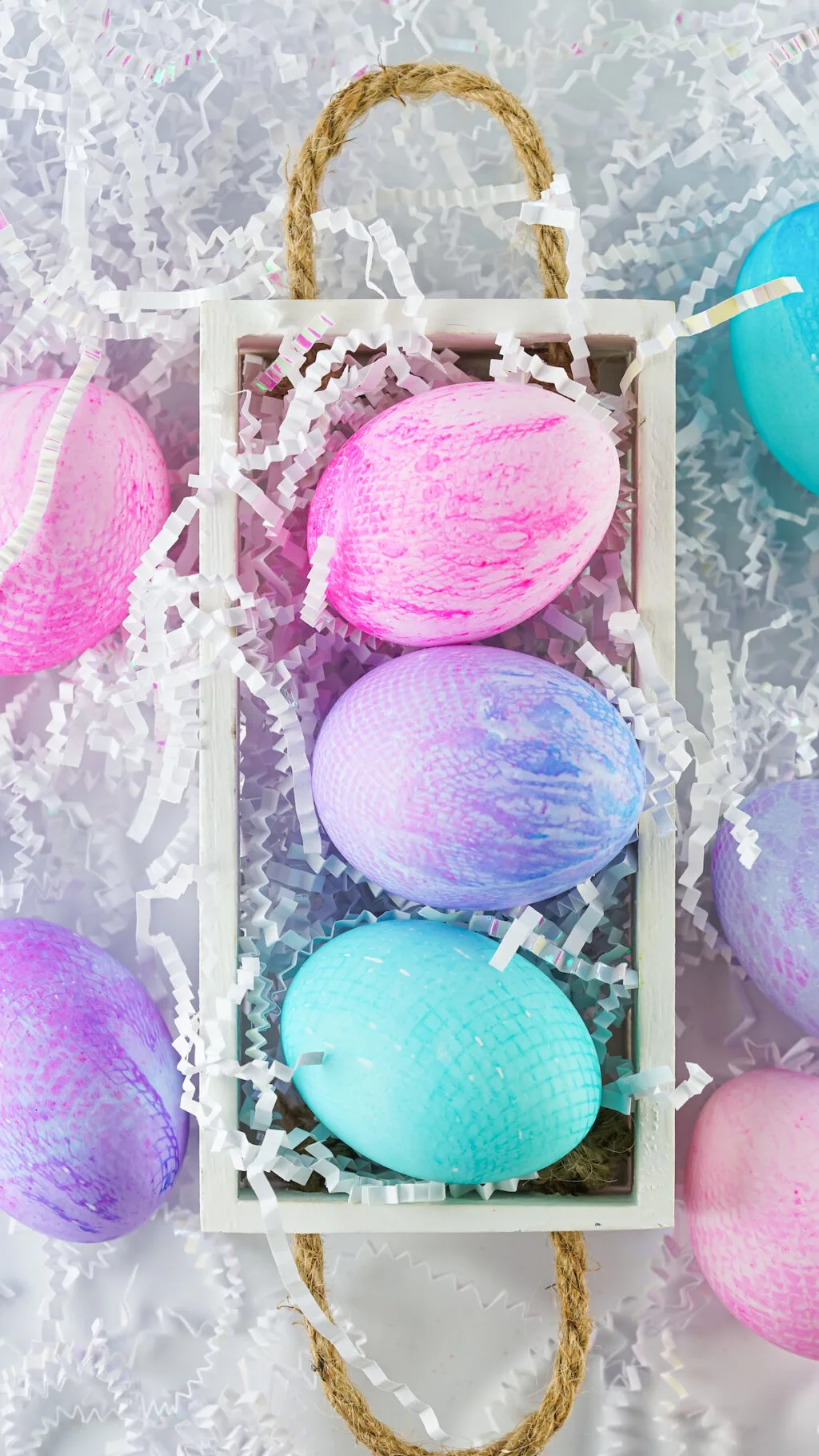 fabric dyed easter eggs in white box on table