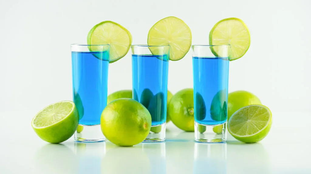 bright blue kamikaze shots on white table lined up