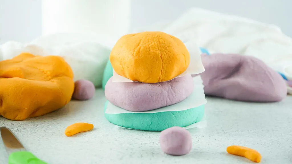 colored homemade playdough stacked on top of each other