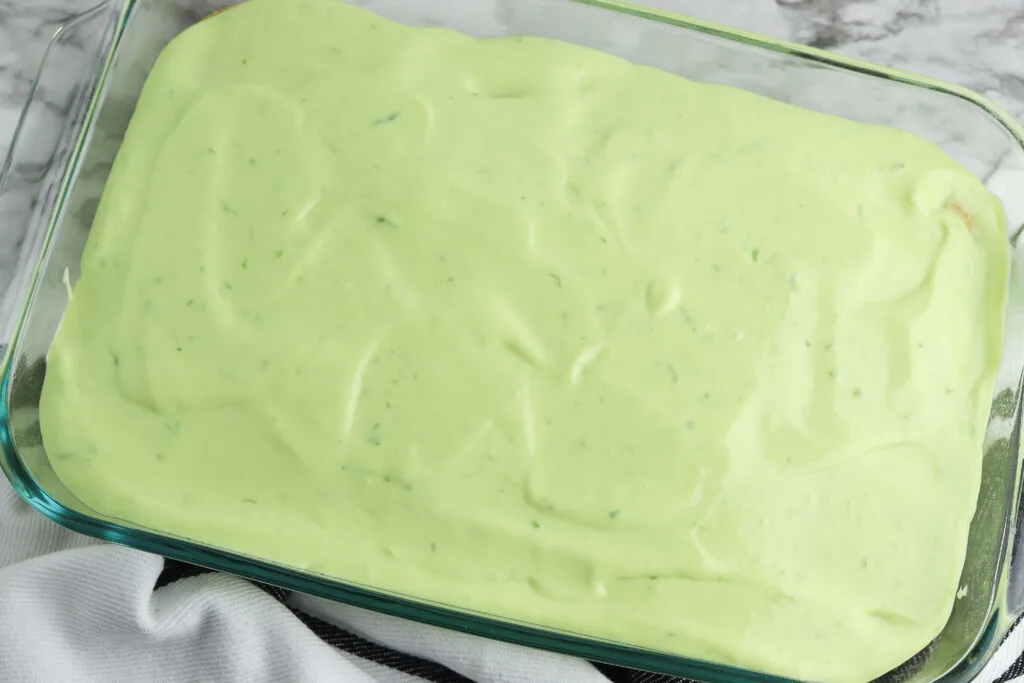 key lime poke cake covered with green topping