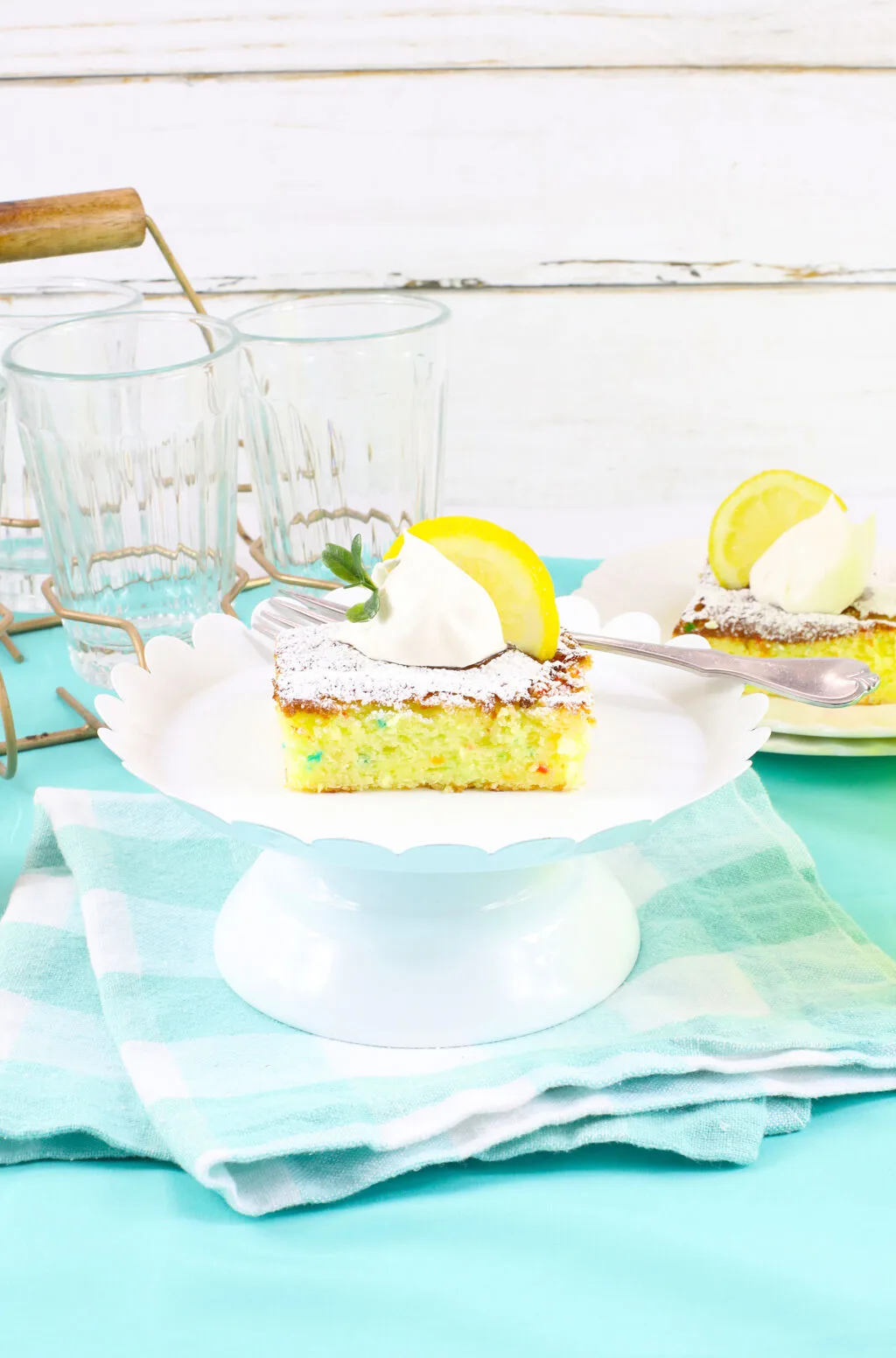 single slice of lemon cake bar on white cake tray