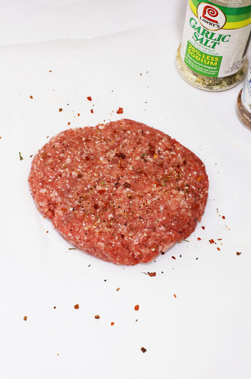 raw seasoned beef burger patty