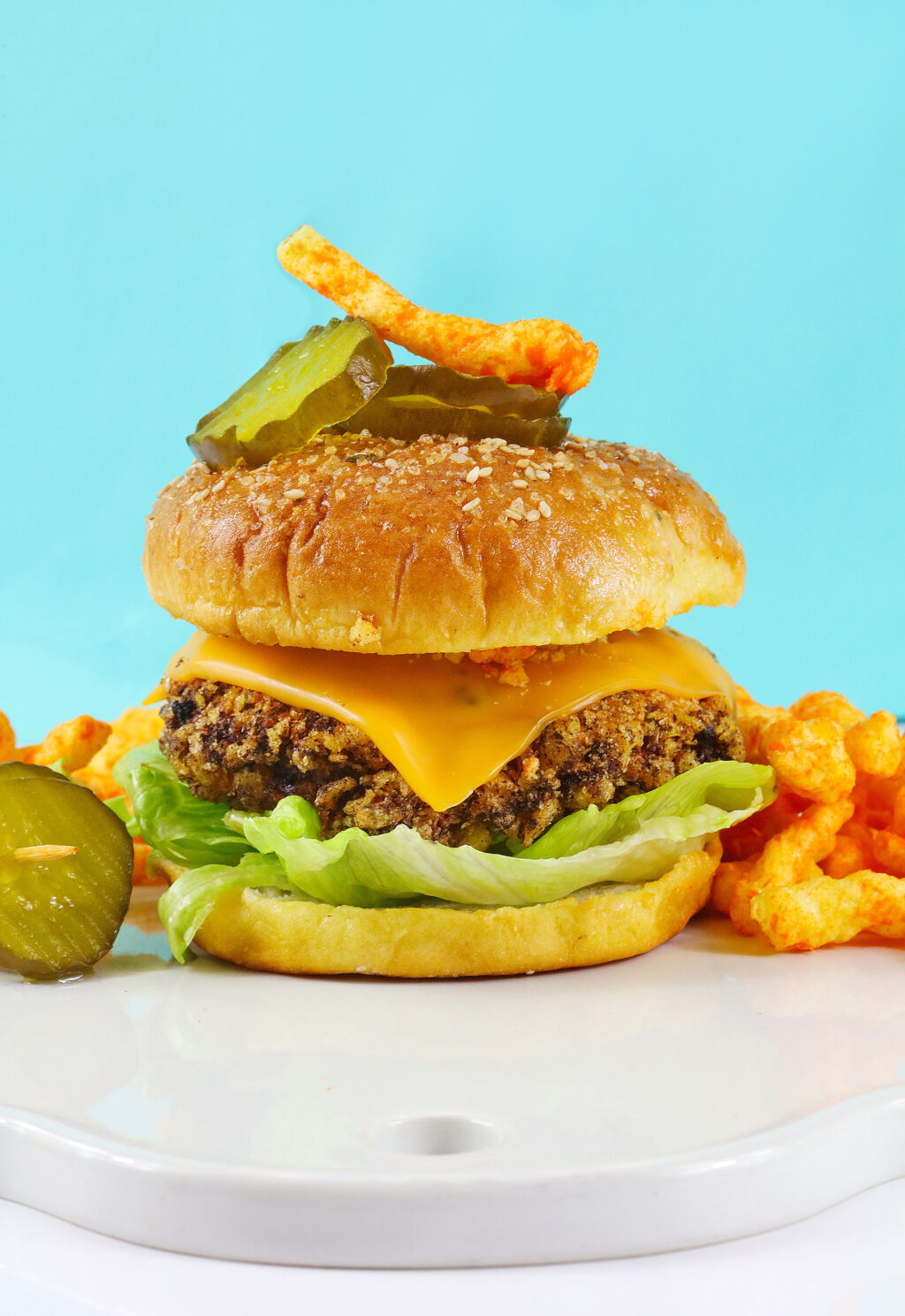 cheetos cheeseburger on table with blue background