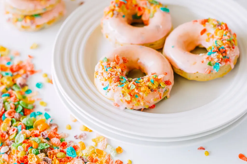 fruity pebbles donuts on white plates