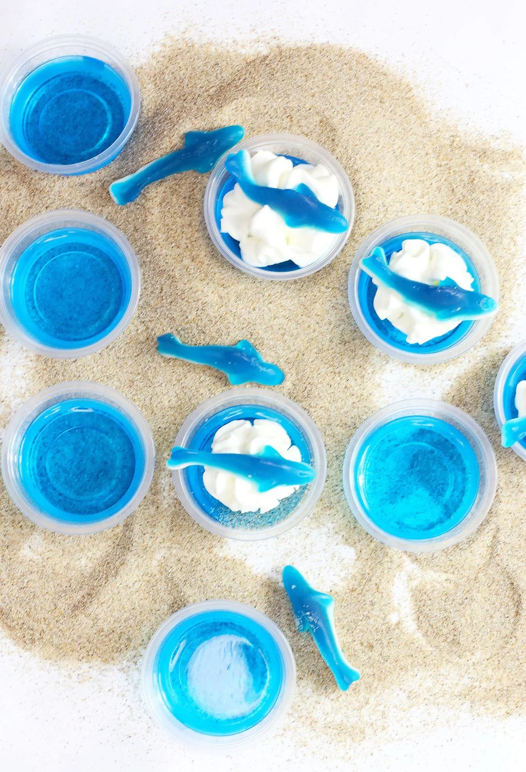 ocean water jello shots on sandy background