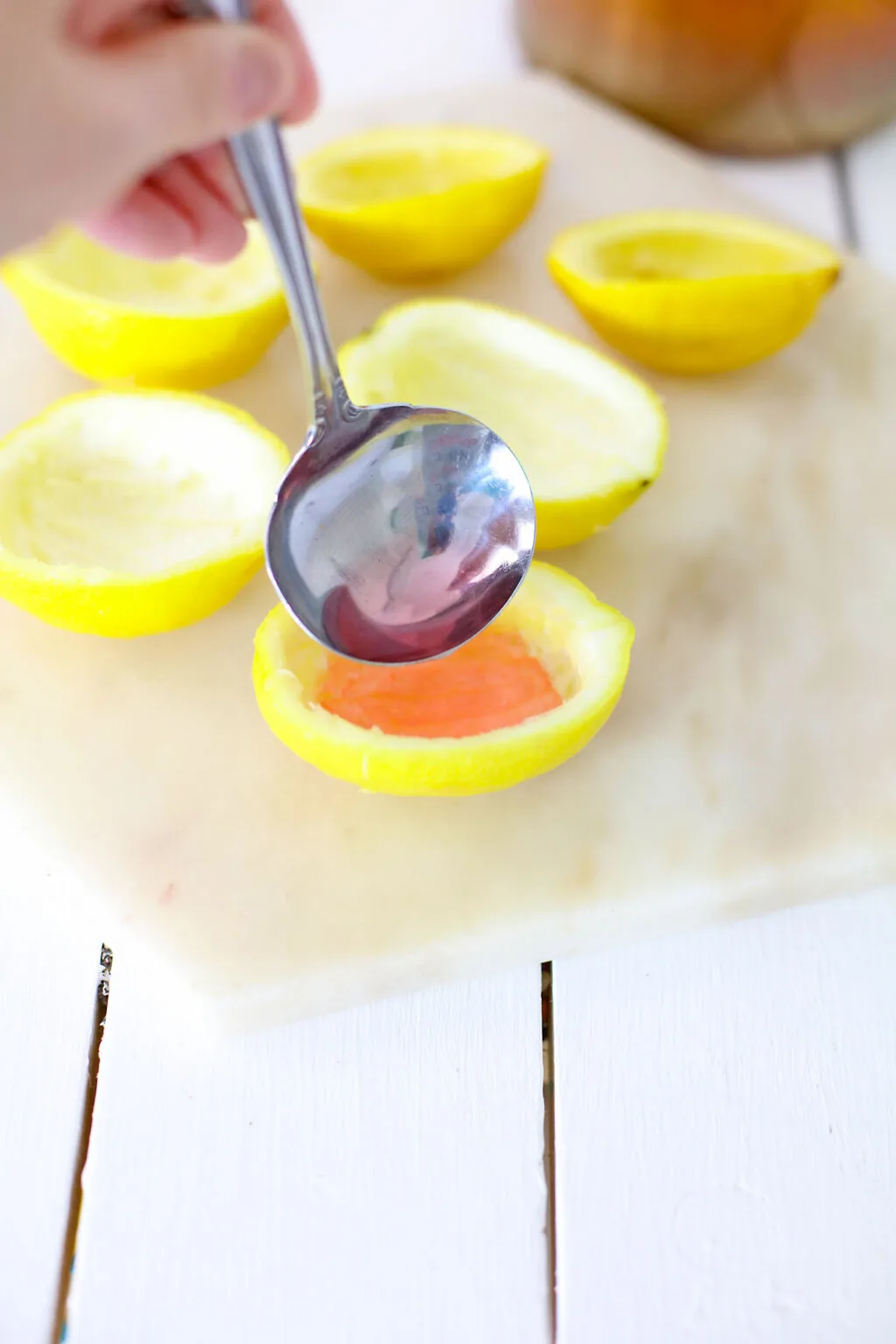 filling lemon rinds with pink lemonade mixture