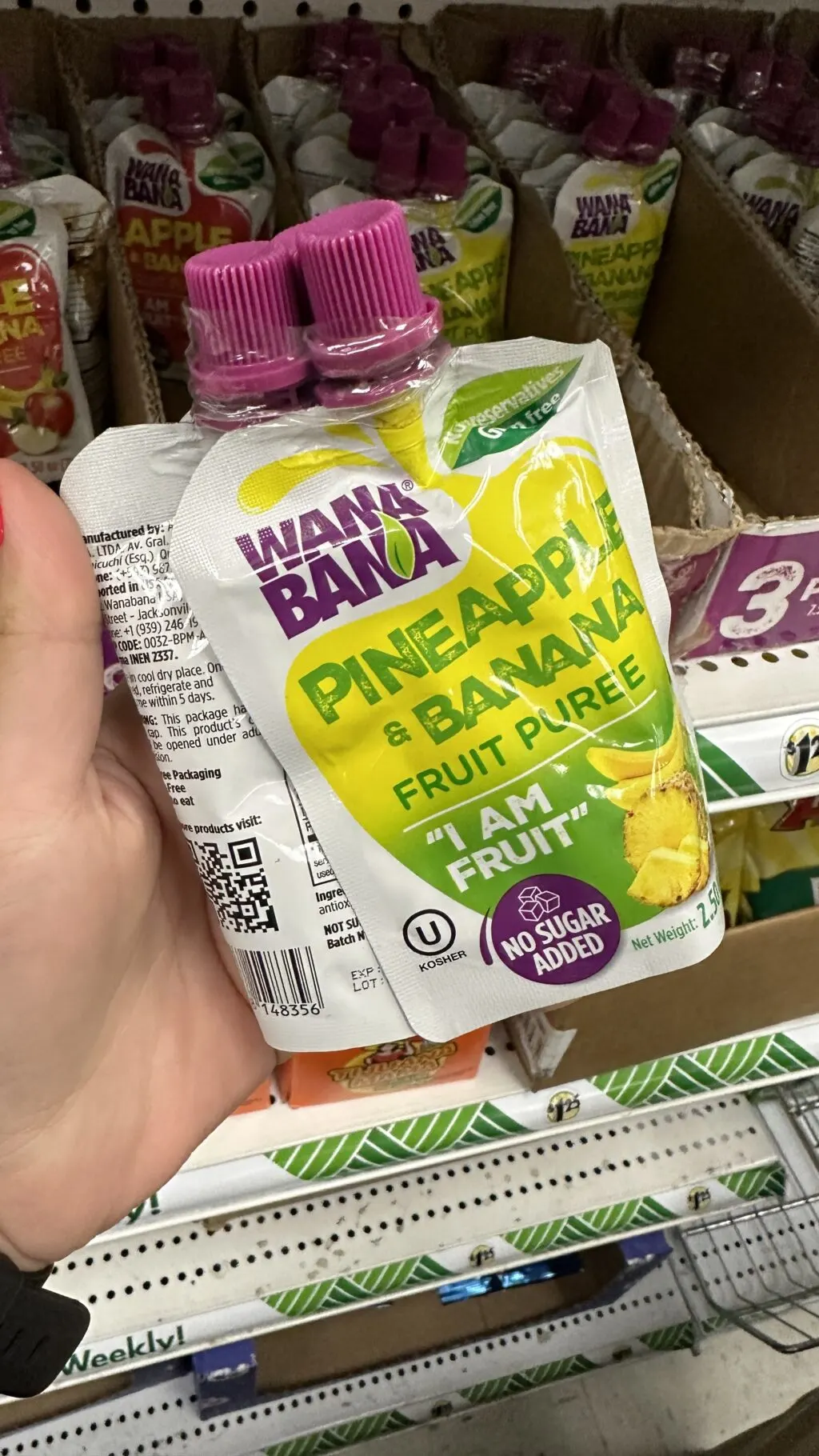 hand holding fruit pouch at dollar tree