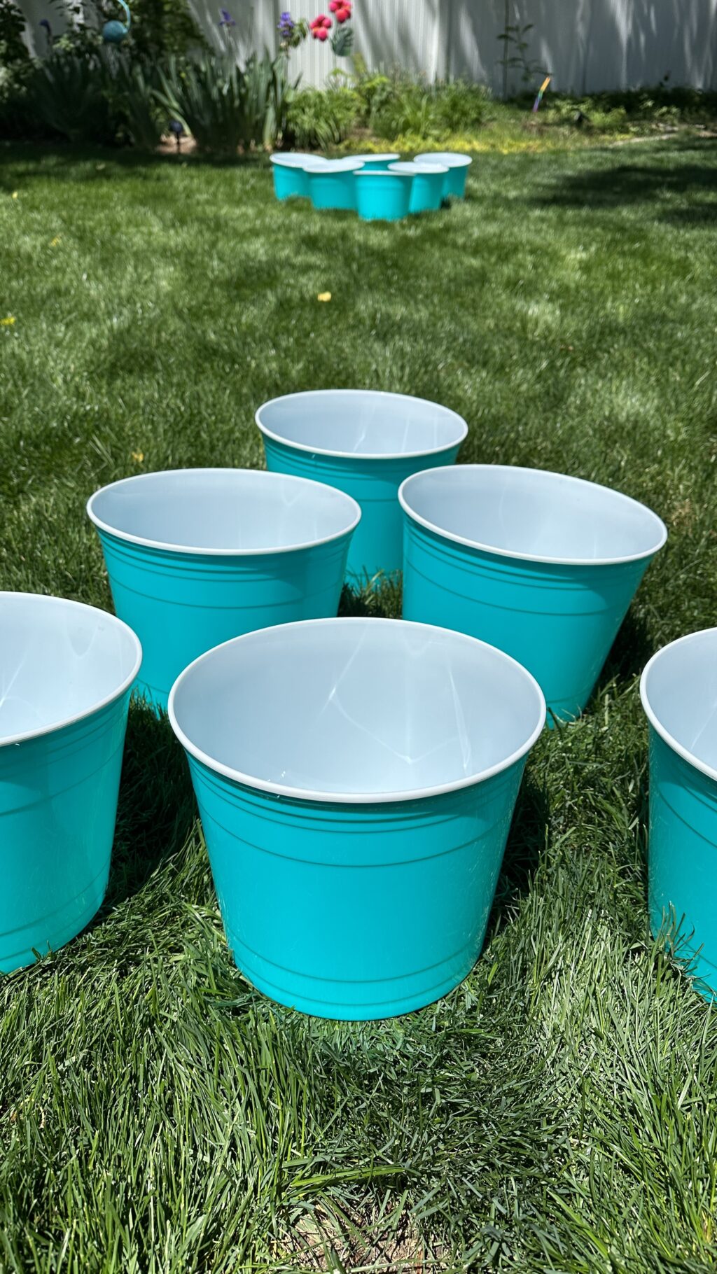 giant aqua yard pong buckets set up in grass