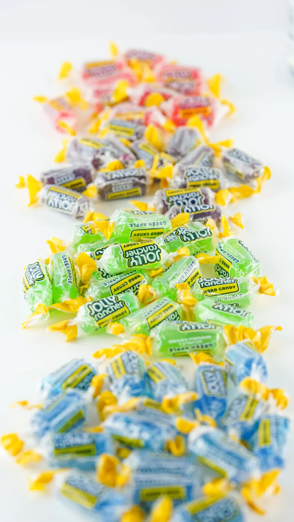 jolly ranchers sorted by color on white table