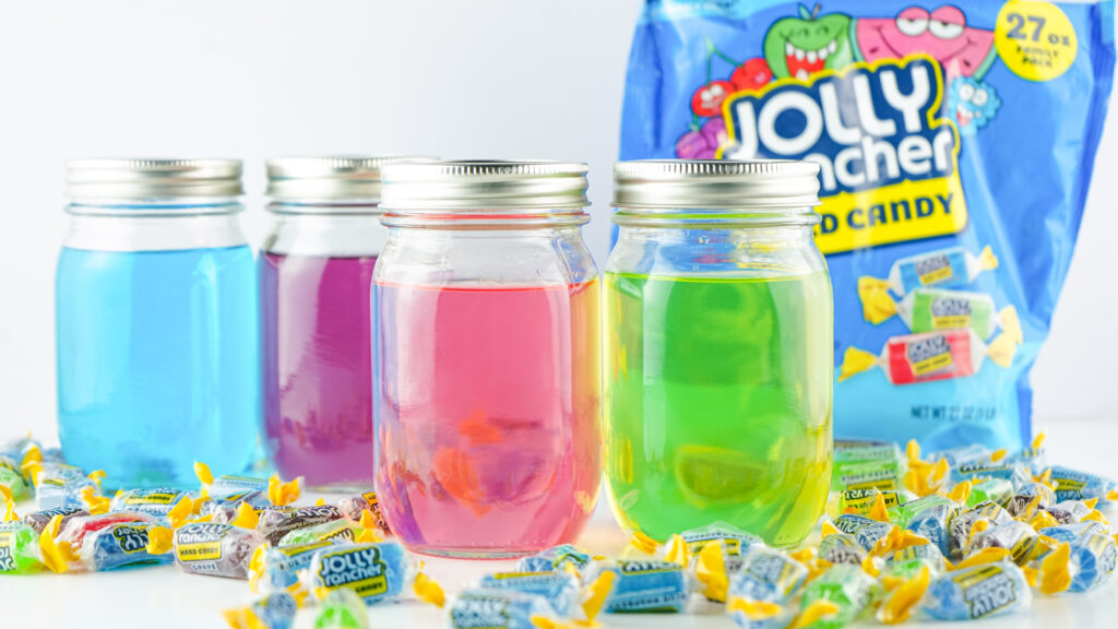 jolly ranchers surrounding jolly rancher vodka on white table