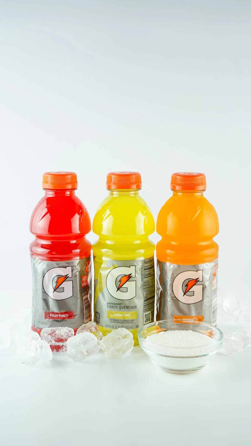 gatorade bottles, ice and sugar on white table