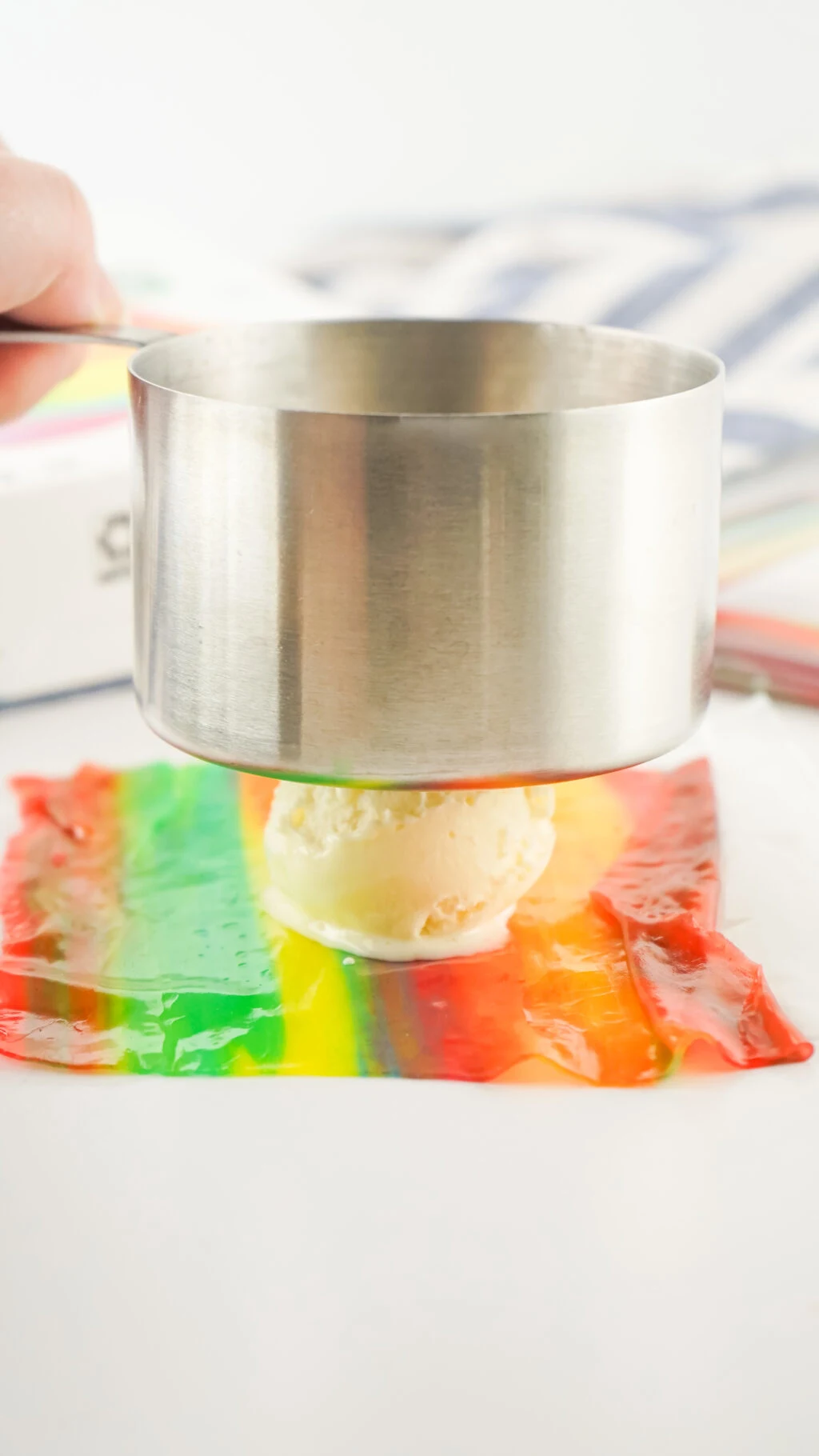 measuring cup smashing ice cream on top of fruit roll up 