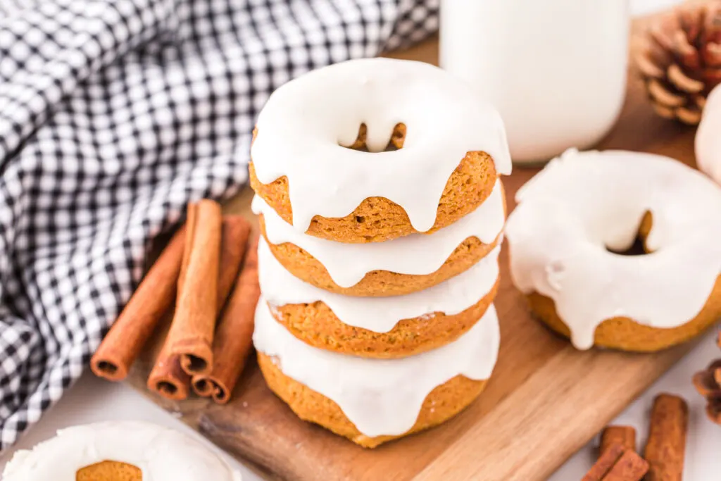 homemade 3-ingredient pumpkin donuts stacked on cutting board