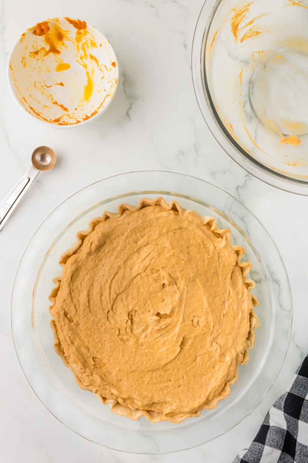 no bake pumpkin pie inside pie crust ready to be placed into fridge